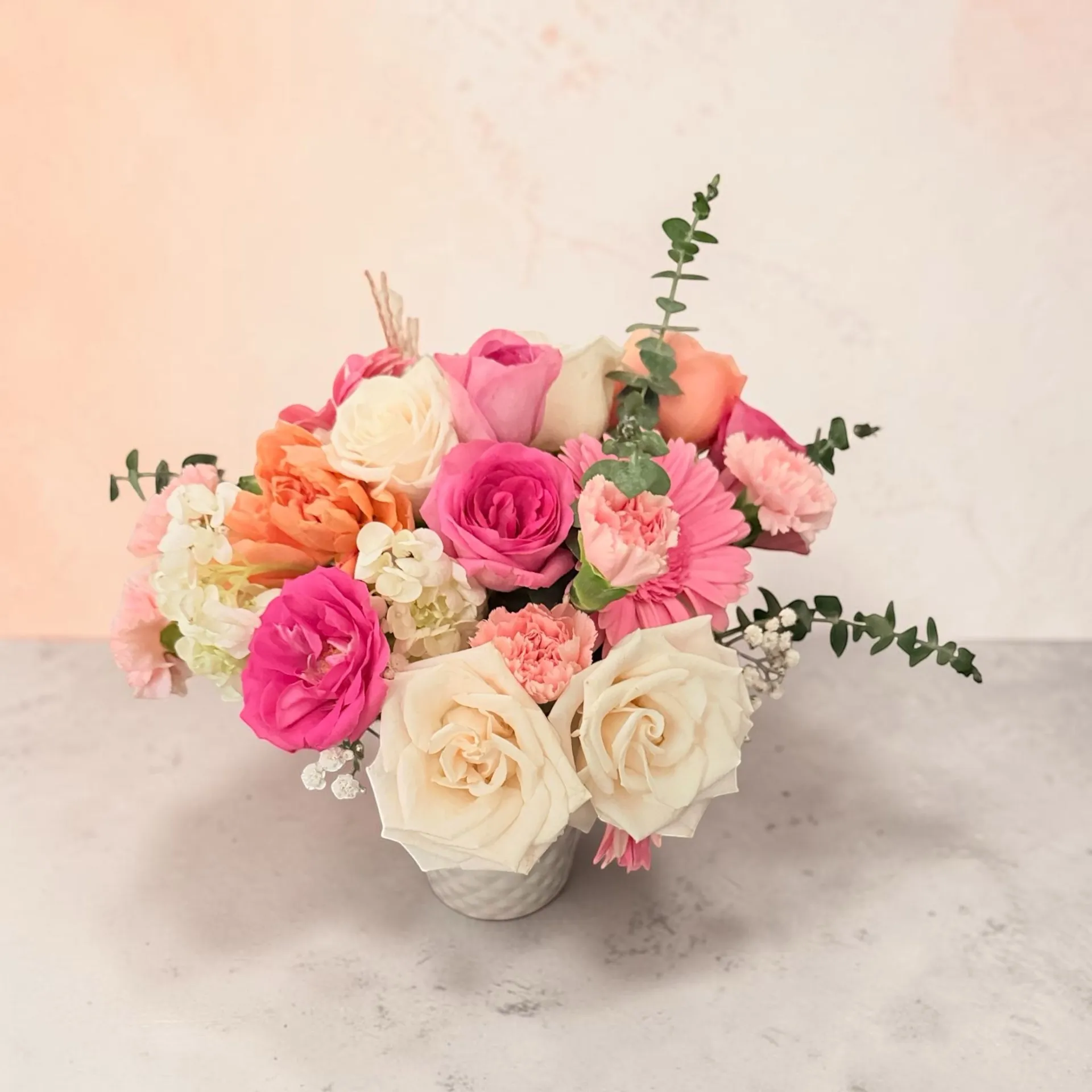 Fresh seasonal flowers displayed in a bright greenhouse studio